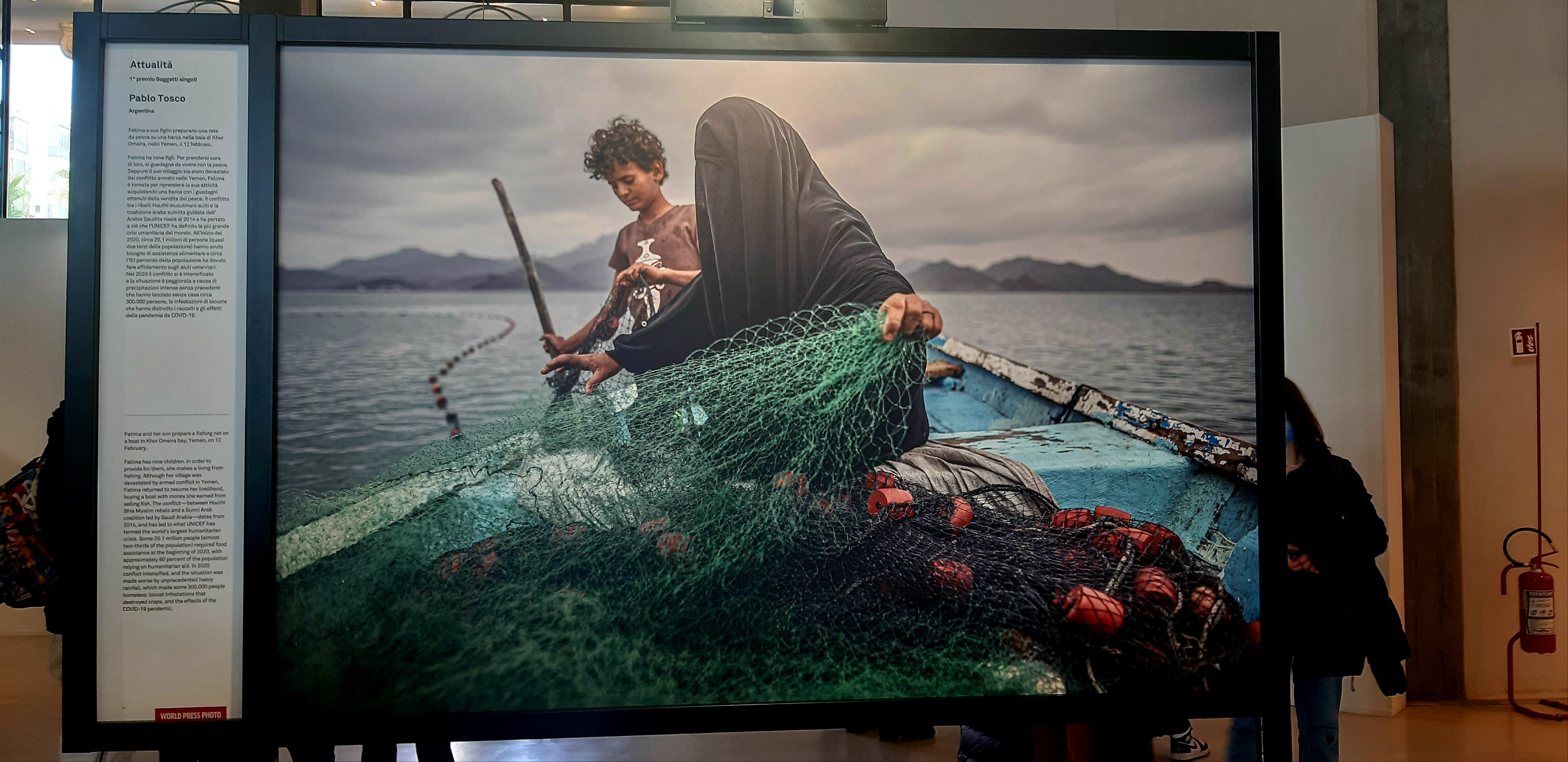World Press Photo - Fatima and her son prepare a fishing net on a